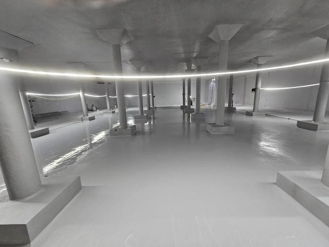 Interior of a clean water reservoir with a protective coating system applied to the floor and columns