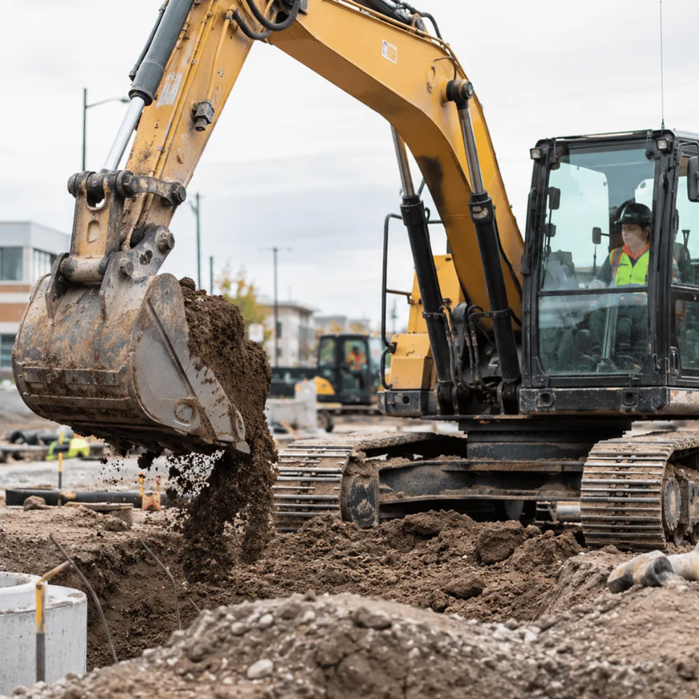 Excavator operator digging a trench on a groundworks site